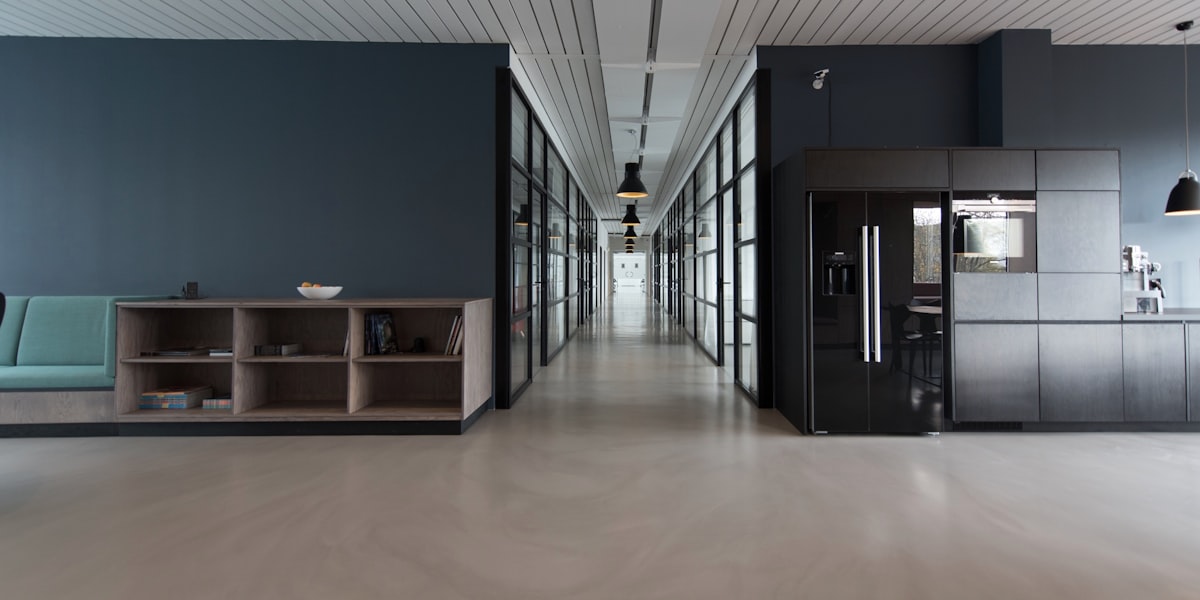 Modern office building interior with glass partitions and open plan workspace
